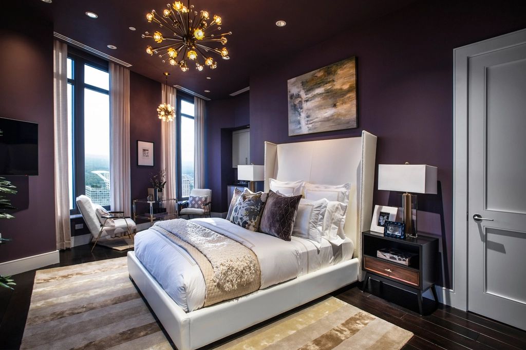 A guest room with a large bed and soft lighting